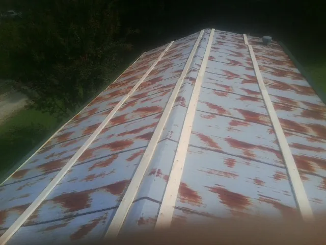 Rusted metal roof panels with new wood purlins before replacement — Storm Damage Roof Repair in Old Lyme by Roofing Brothers