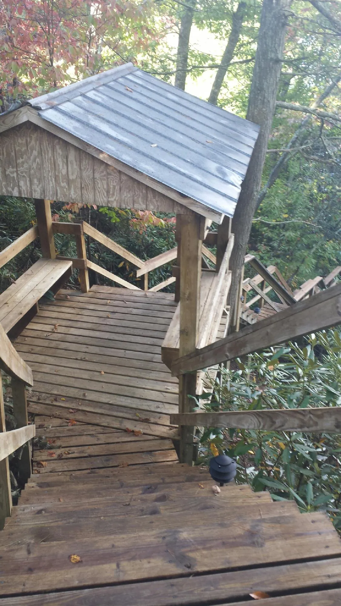 Metal roofed shelter over wooden steps on a wooded walkway — Skylight Repair & Installation work by our crew in Old Lyme